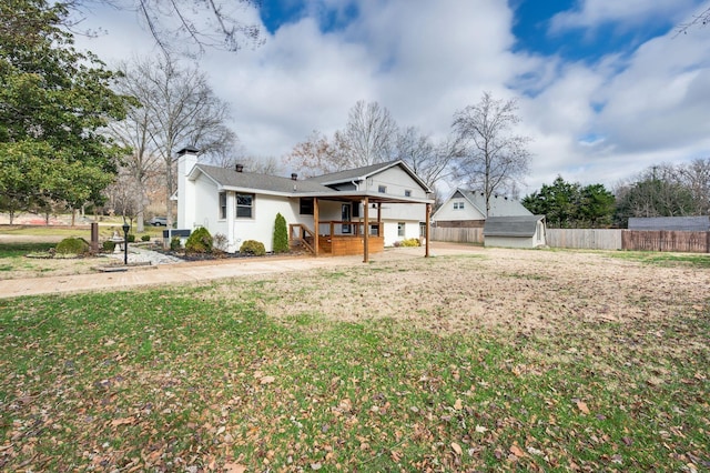 exterior space with a yard, a chimney, and fence