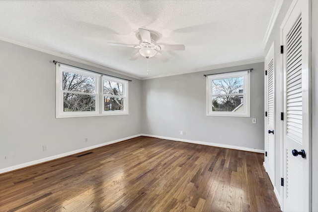 unfurnished bedroom with baseboards, dark wood-style floors, visible vents, and a textured ceiling