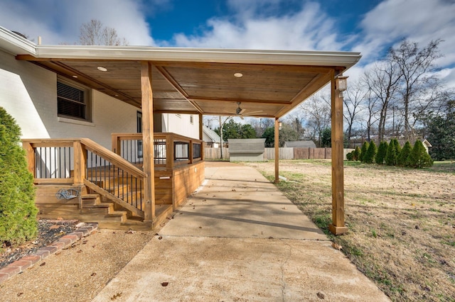 view of patio with an outdoor structure and fence