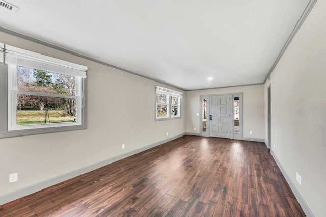 interior space with visible vents, baseboards, dark wood-style flooring, and crown molding