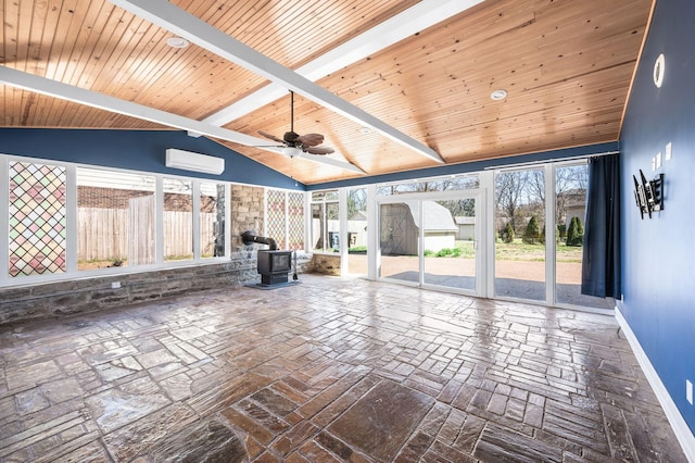 unfurnished living room featuring vaulted ceiling with beams, baseboards, wood ceiling, a wood stove, and a wall mounted AC