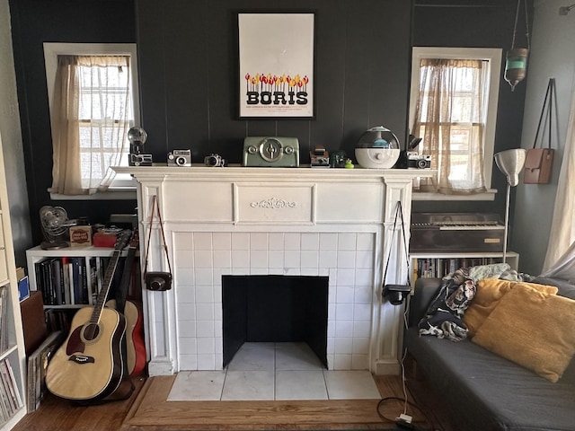 living room featuring a wealth of natural light and a tile fireplace