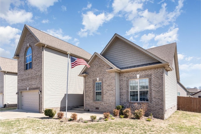 view of front of house featuring a front lawn, fence, concrete driveway, crawl space, and brick siding