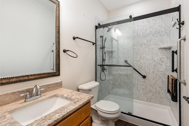 full bath featuring vanity, a shower stall, and toilet