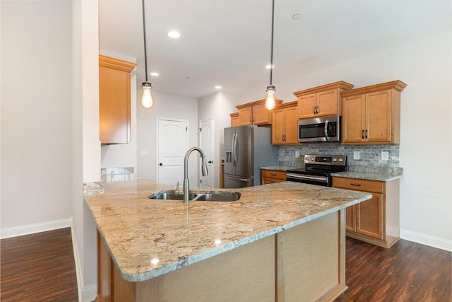 kitchen featuring backsplash, dark wood-type flooring, light stone counters, stainless steel appliances, and a sink