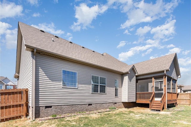 rear view of house featuring crawl space, a shingled roof, a sunroom, and fence