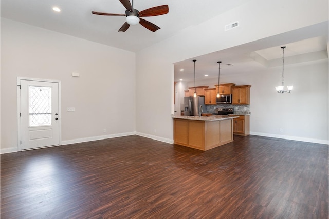 kitchen with open floor plan, ceiling fan with notable chandelier, visible vents, and stainless steel appliances