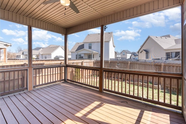 deck with a fenced backyard, a residential view, and ceiling fan