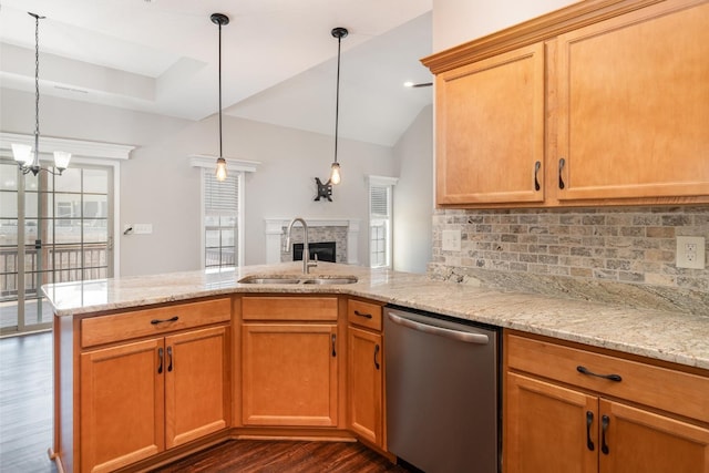 kitchen featuring tasteful backsplash, a sink, dishwasher, a fireplace, and dark wood-style flooring