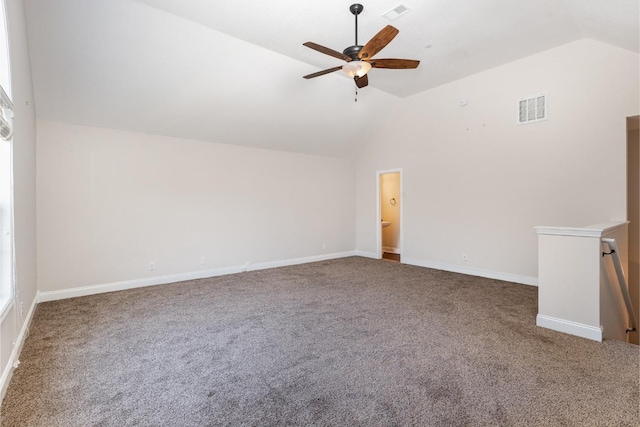 interior space with vaulted ceiling, a ceiling fan, visible vents, and baseboards