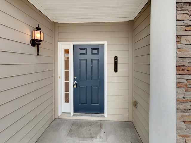 property entrance featuring stone siding