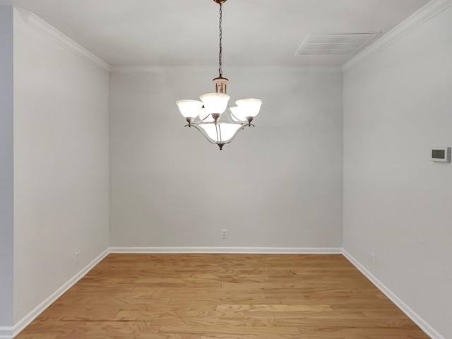 spare room with visible vents, baseboards, light wood-style floors, and ornamental molding