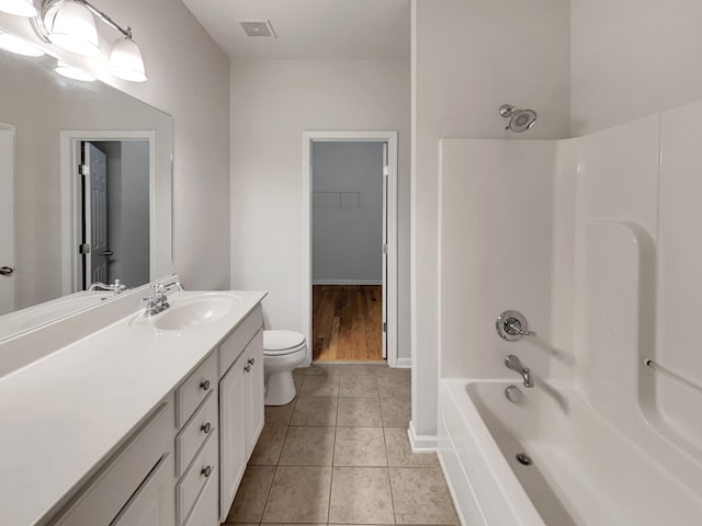 full bath with tile patterned floors, toilet, baseboards, bathing tub / shower combination, and vanity