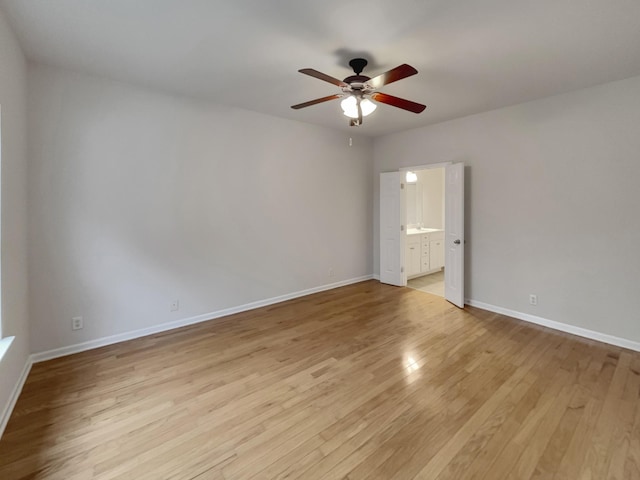 empty room featuring baseboards, light wood-style floors, and ceiling fan