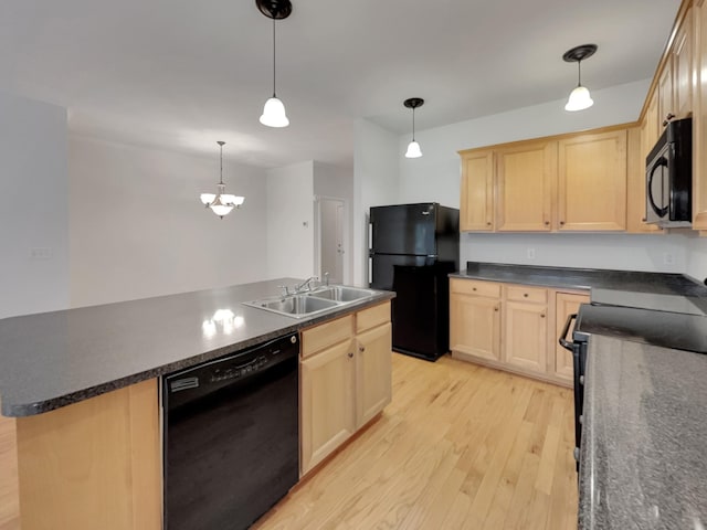 kitchen with black appliances, light wood-style flooring, light brown cabinetry, a sink, and dark countertops