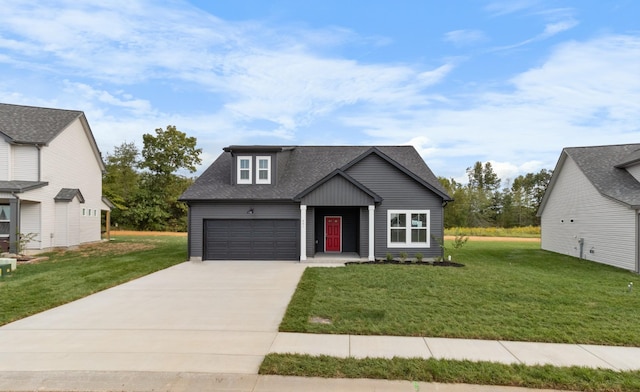 view of front of property featuring a front yard, an attached garage, driveway, and a shingled roof