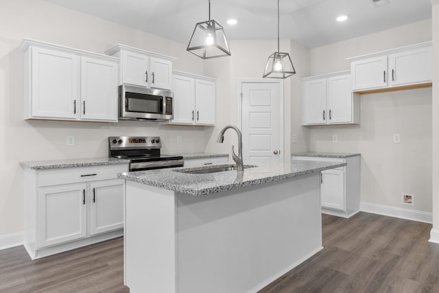 kitchen featuring dark wood-style floors, white cabinets, appliances with stainless steel finishes, and a sink