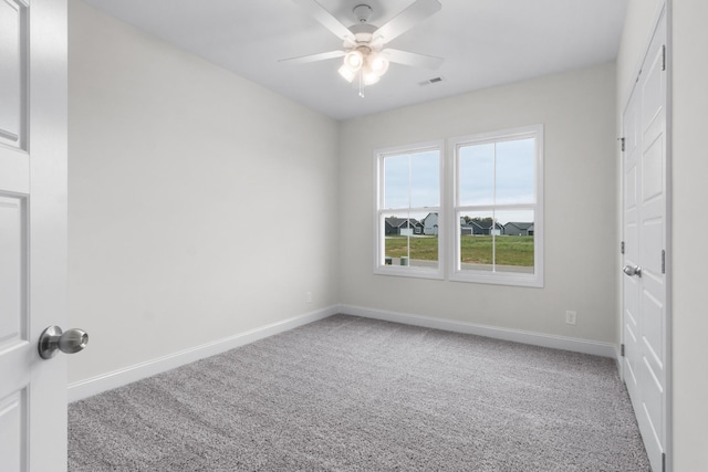 unfurnished bedroom with visible vents, a ceiling fan, baseboards, and carpet floors