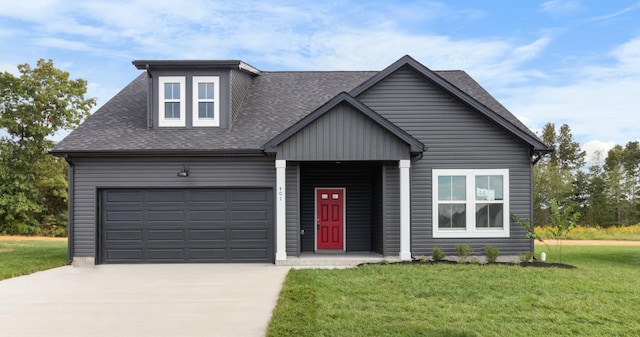 view of front of property featuring a garage, roof with shingles, concrete driveway, and a front yard