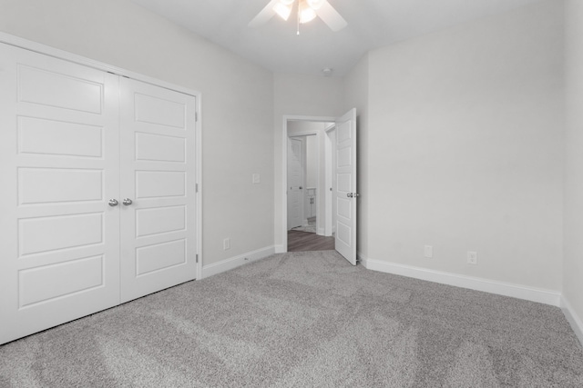 unfurnished bedroom featuring a ceiling fan, carpet, baseboards, and a closet