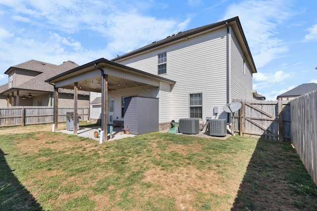 back of property featuring central AC, a yard, a patio area, and a fenced backyard