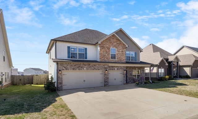 craftsman-style home with driveway, a front yard, and a garage