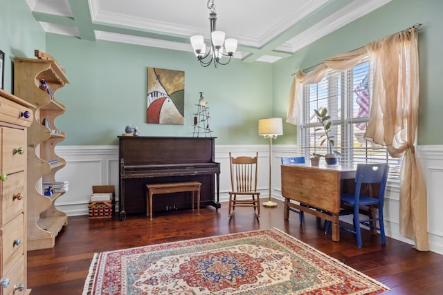 living area featuring hardwood / wood-style floors, a chandelier, and wainscoting