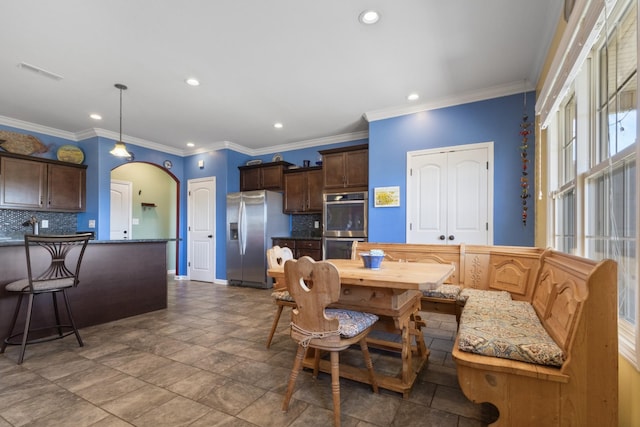 dining area with recessed lighting, visible vents, arched walkways, and ornamental molding