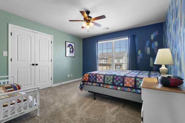 carpeted bedroom featuring a closet, visible vents, a ceiling fan, and baseboards