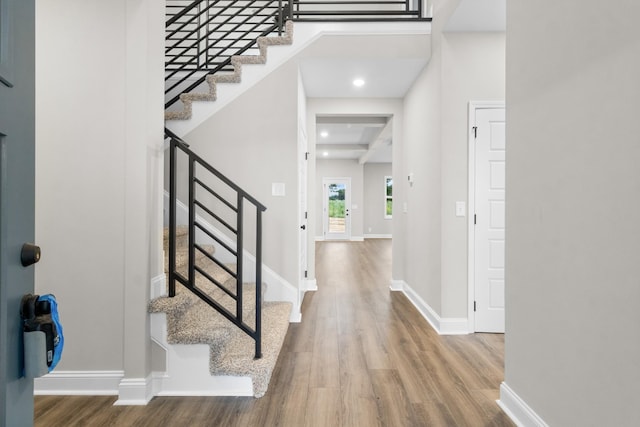 entryway featuring stairway, wood finished floors, and baseboards