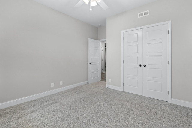 unfurnished bedroom featuring visible vents, a ceiling fan, a closet, carpet flooring, and baseboards