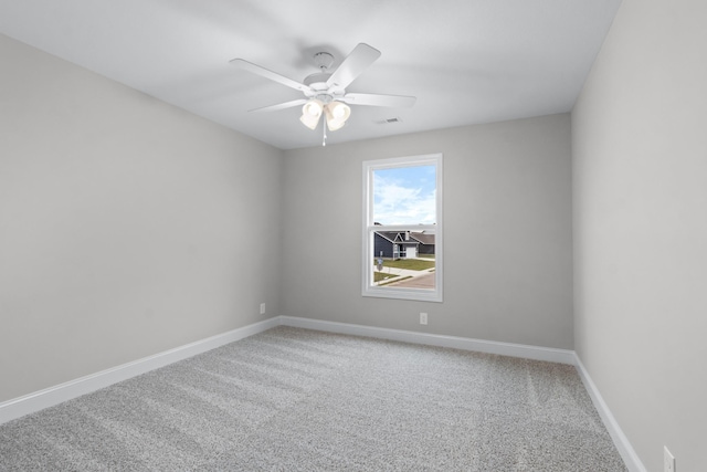 unfurnished room featuring carpet flooring, visible vents, baseboards, and ceiling fan