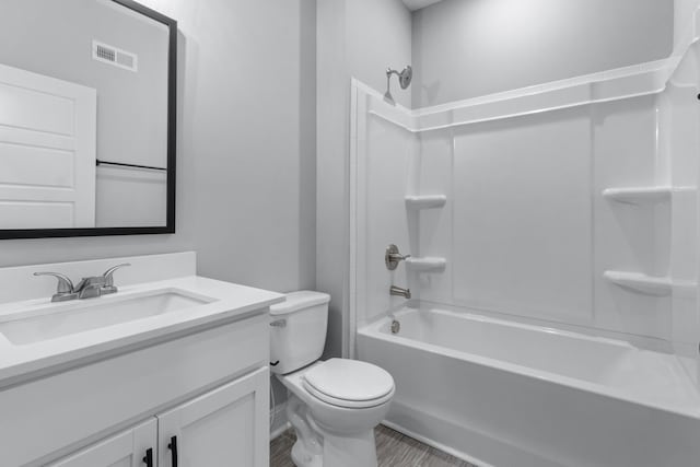 bathroom featuring visible vents, toilet, vanity, and washtub / shower combination