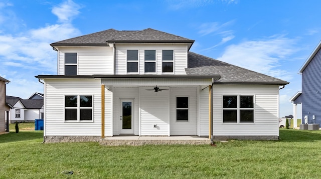 back of property with a patio area, a yard, a ceiling fan, and a shingled roof