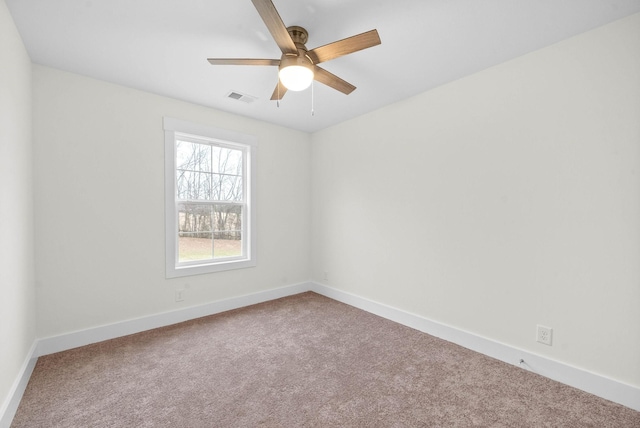 unfurnished room featuring a ceiling fan, carpet, visible vents, and baseboards