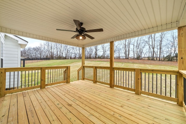 wooden deck with a yard and a ceiling fan