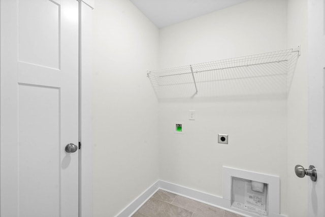 washroom with baseboards, hookup for an electric dryer, hookup for a washing machine, and laundry area