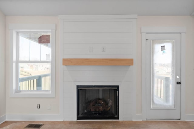 details with visible vents, a fireplace, and baseboards