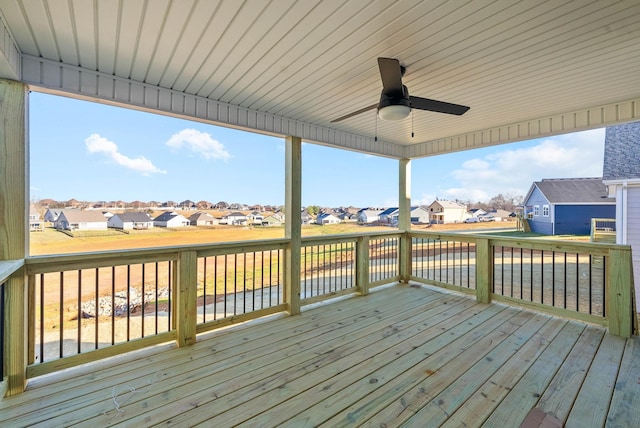 wooden deck with a residential view and ceiling fan