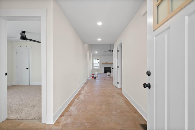 hall with recessed lighting, visible vents, and baseboards