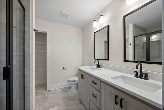 bathroom featuring a spacious closet, visible vents, a shower stall, and a sink