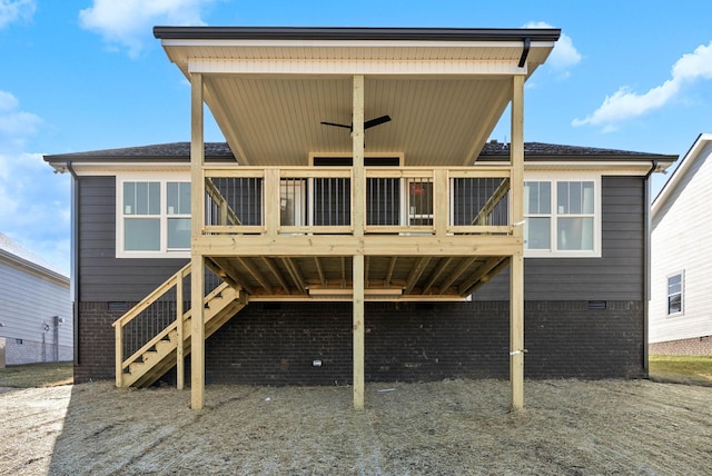 back of property with stairs and brick siding