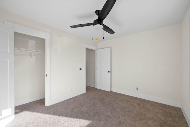 unfurnished bedroom with a closet, baseboards, a ceiling fan, and carpet flooring