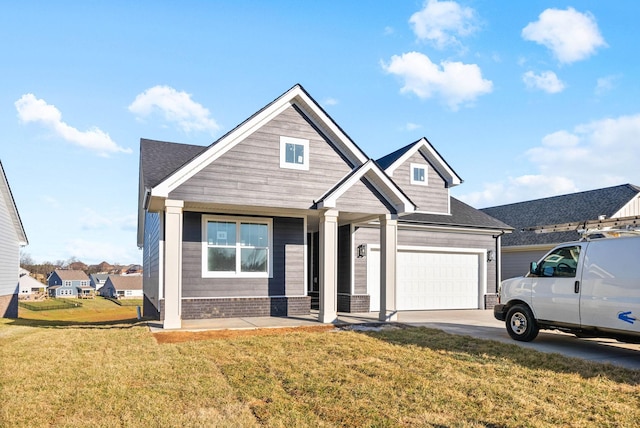 view of front of property featuring a garage, concrete driveway, and a front lawn