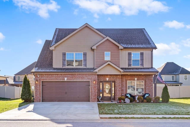 view of front of property with driveway, a front lawn, fence, an attached garage, and brick siding