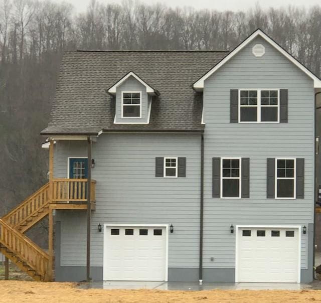 exterior space featuring stairs and a garage