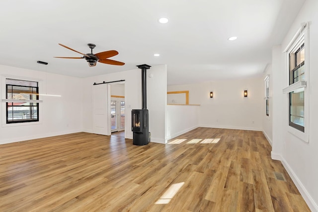 empty room featuring recessed lighting, visible vents, light wood-style flooring, and baseboards