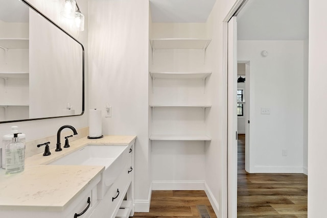 bathroom with visible vents, baseboards, wood finished floors, and vanity