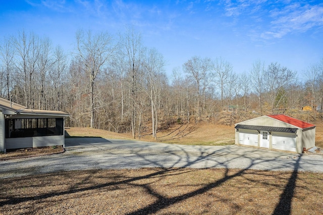 view of street with a view of trees and driveway