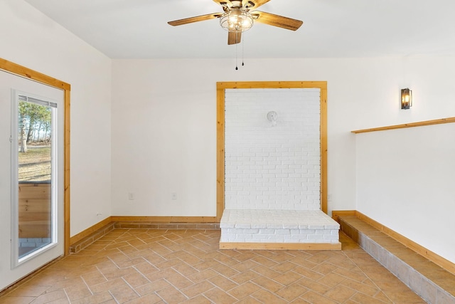 empty room featuring baseboards and ceiling fan